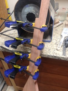 Clamps holding together the wood on my saw-scarred paddle.